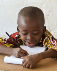 kid writing on his notebook