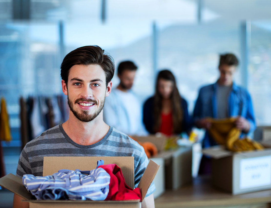 man holding box of donation