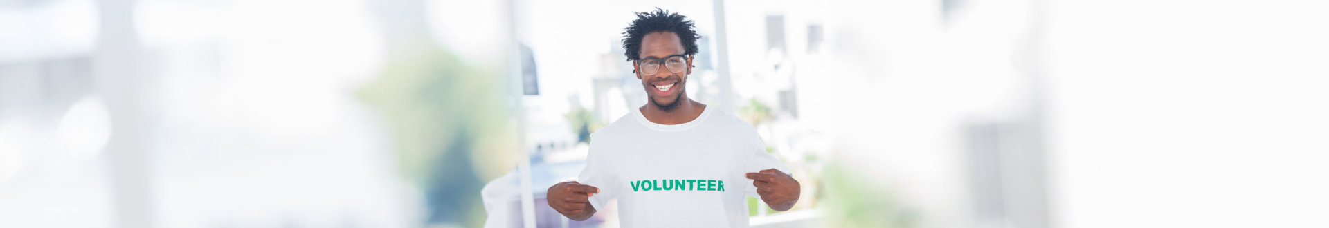 man smiling with his volunteer tshirt